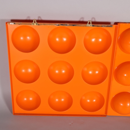 32 - A pair of orange plastic moulded wall-hanging panels, 58cm square