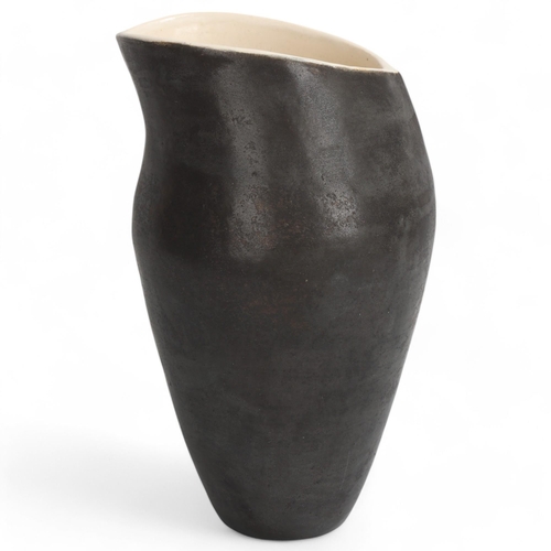 68 - DEANA MOORE, British, a hand-coiled vessel with burnished black exterior and white internal glaze, m... 