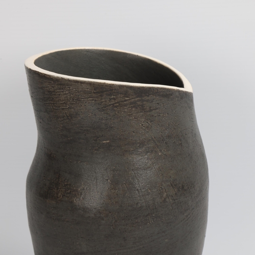 69 - DEANA MOORE, British, hand-coiled vessel with burnished black exterior and white rim, impressed make... 