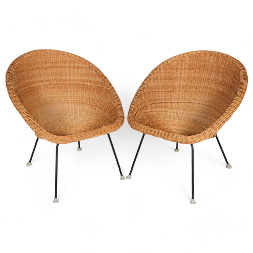 77 - A pair of mid-century wicker saucer chairs on iron legs, height 74cm