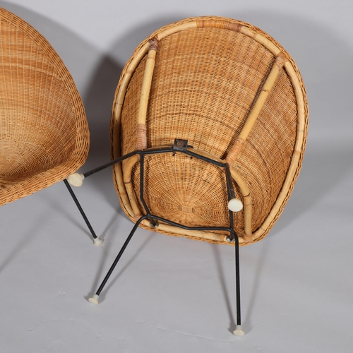 77 - A pair of mid-century wicker saucer chairs on iron legs, height 74cm