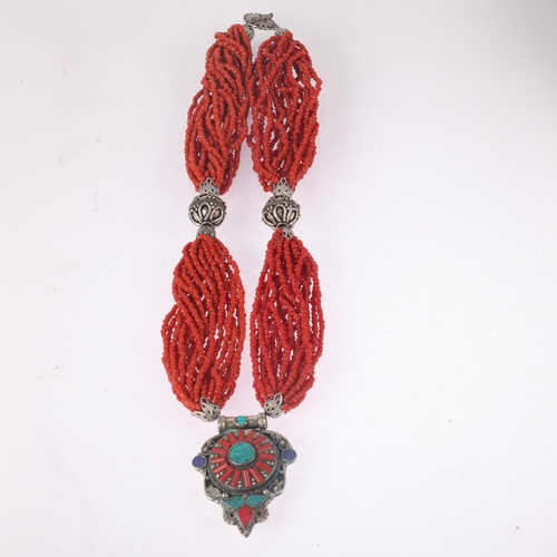 1491 - A Tibetan multi-strand coral bead necklace, with white metal coral pendant, pendant 59.5mm, necklace... 