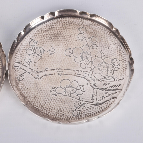 1588 - A pair of Japanese silver drink's coasters, with engraved blossom decoration, 8cm, 2oz total