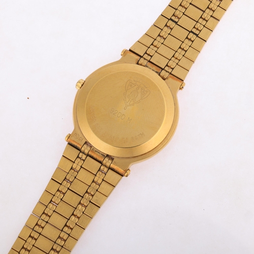 1012 - GUCCI - a gold plated 9200M quartz calendar bracelet watch, black dial with gilt baton hour markers,... 