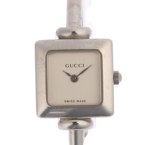 1015 - GUCCI - a lady's stainless steel 1900L quartz bangle watch, circa 2000, square silvered dial with le... 