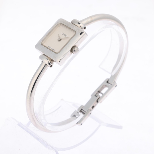 1015 - GUCCI - a lady's stainless steel 1900L quartz bangle watch, circa 2000, square silvered dial with le... 