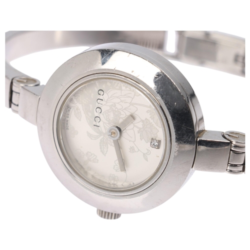 1023 - GUCCI - a lady's stainless steel 105 Series quartz bangle watch, silvered floral dial with diamond h... 