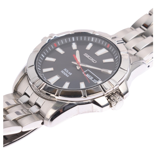 1042 - SEIKO - a stainless steel Solar 100M quartz day/date bracelet watch, ref. V158-0AH0, black dial with... 