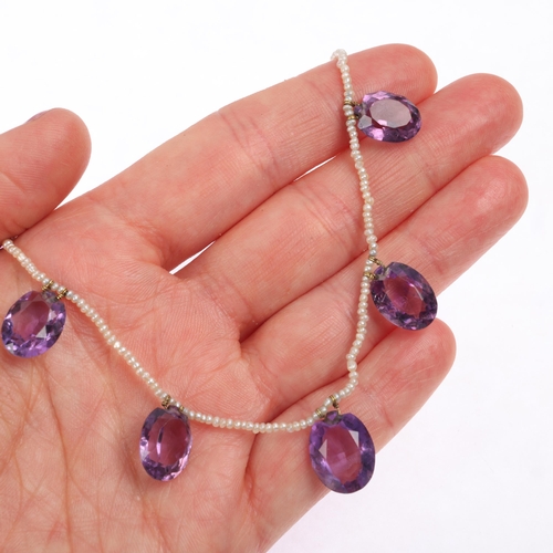 1100 - An Edwardian amethyst and seed pearl fringe necklace, the single row of seed pearls suspending 7 gra... 