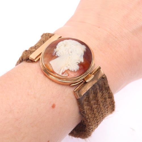 1110 - An Antique Victorian shell cameo hairwork bracelet, the oval cameo relief carved depicting Classical... 