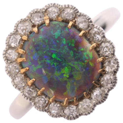 1122 - A platinum black opal and diamond cluster ring, centrally claw set with oval cabochon black opal sur... 