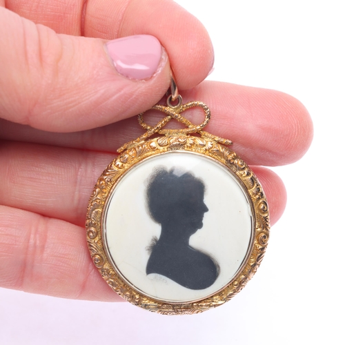 1124 - A Georgian silhouette locket pendant, by John Miers (1758 - 1821), the circular hand painted panel d... 