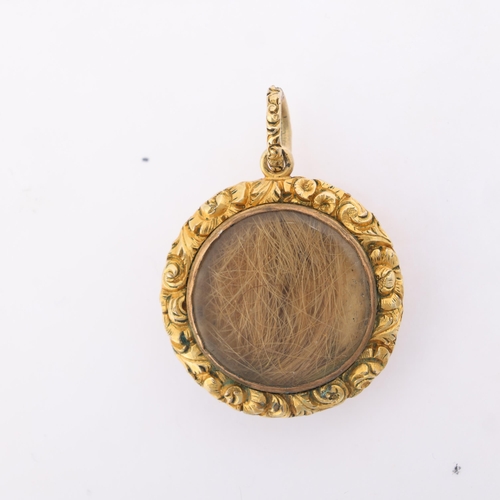 1132 - An Antique Victorian turquoise and pearl mourning locket pendant, of circular form, with engine turn... 