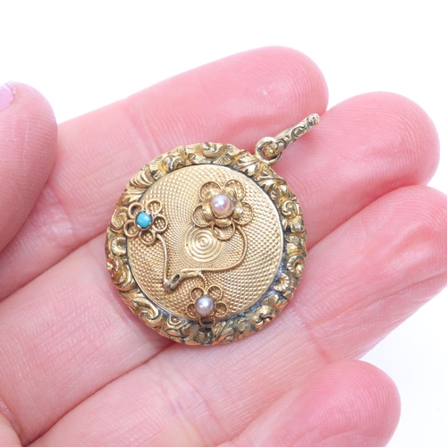 1132 - An Antique Victorian turquoise and pearl mourning locket pendant, of circular form, with engine turn... 