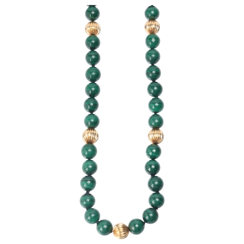 1144 - A long single strand 14ct gold malachite bead necklace, set with 10mm malachite beads having 7 x 14c... 