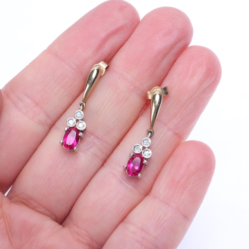 1145 - A pair of 9ct gold ruby and diamond drop stud earrings, set with oval mixed-cut rubies and single-cu... 