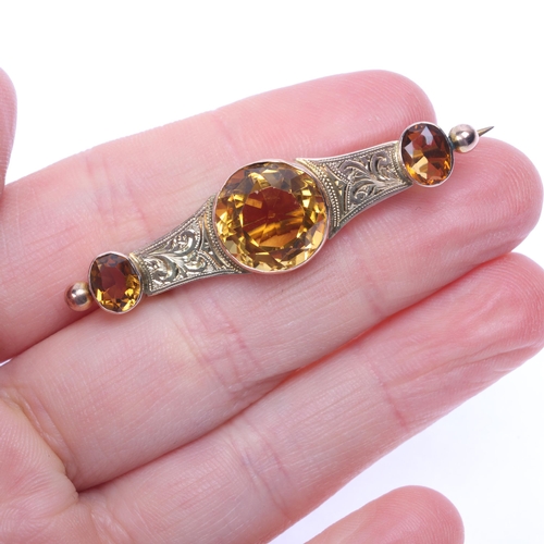 1151 - An Antique 9ct rose gold citrine brooch, set with round oval-cut citrines with foliate engraved deco... 