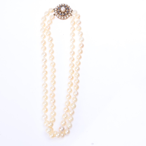 1163 - A Vintage double-strand cultured pearl bead necklace, with 9ct rose gold sapphire and pearl flowerhe... 