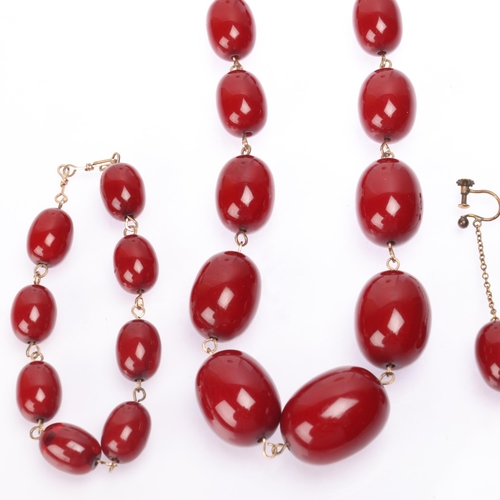 1172 - A Vintage cherry amber bead jewellery set, comprising necklace 45cm, bracelet 20cm, and pair of drop... 