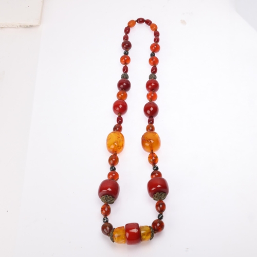 1174 - A Vintage single-strand graduated amber bead necklace, including cherry and butterscotch amber beads... 