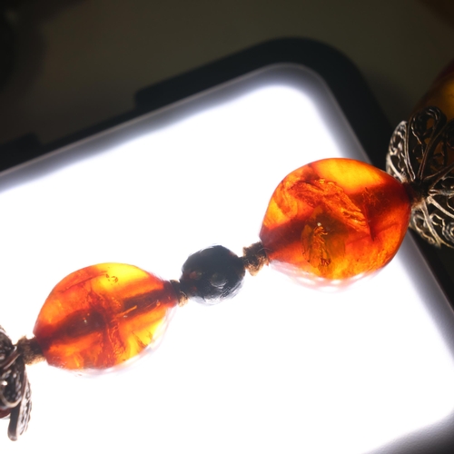 1174 - A Vintage single-strand graduated amber bead necklace, including cherry and butterscotch amber beads... 