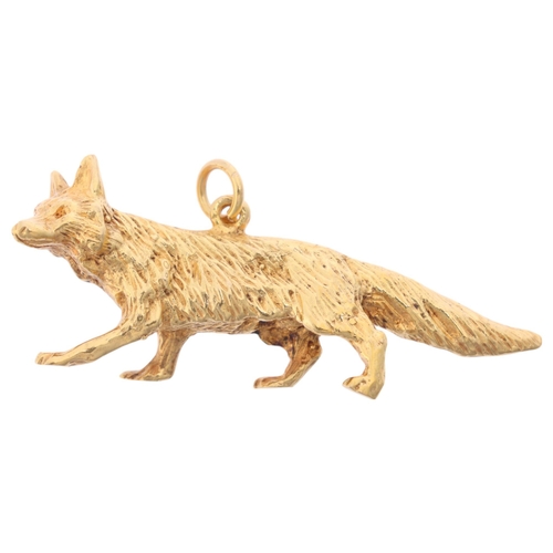 1184 - A 9ct gold fox charm/pendant, maker FM, London 1965, realistically modelled as a prowling fox, 41.8m... 