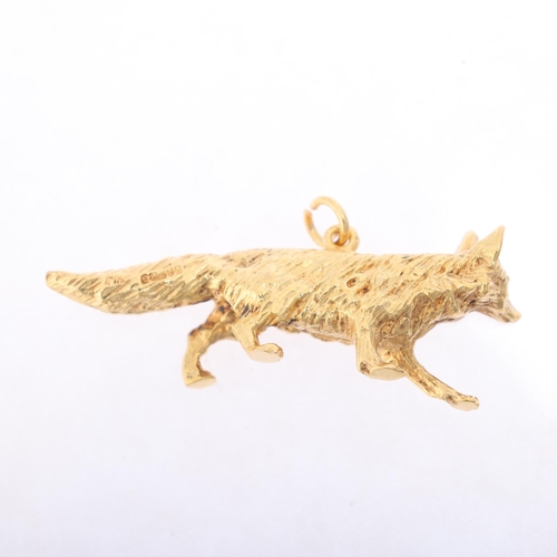 1184 - A 9ct gold fox charm/pendant, maker FM, London 1965, realistically modelled as a prowling fox, 41.8m... 