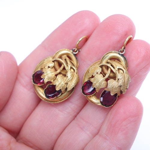 1194 - A pair of Antique Victorian garnet drop earrings, circa 1860, the chased floral motif set with oval ... 