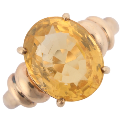 1204 - A 9ct gold single stone citrine dress ring, claw set with oval mixed-cut citrine, setting height 13.... 