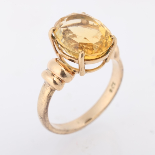 1204 - A 9ct gold single stone citrine dress ring, claw set with oval mixed-cut citrine, setting height 13.... 