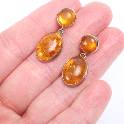 1205 - A pair of 9ct gold amber drop stud earrings, maker EWV, London 1997, set with round and oval cabocho... 