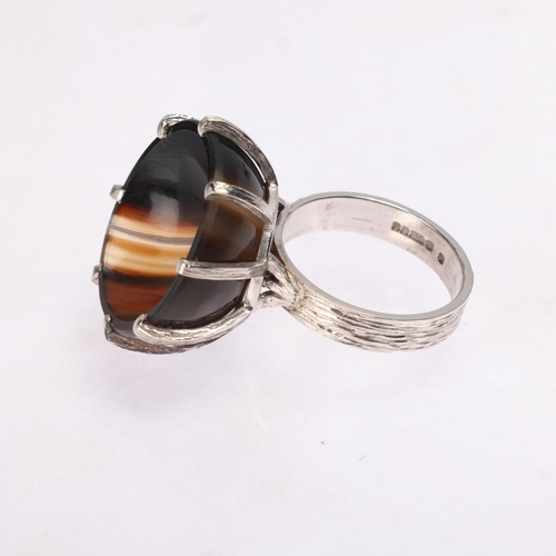 1213 - A Vintage 9ct white gold banded agate cup ring, maker CW, London 1979, set with round polished conca... 