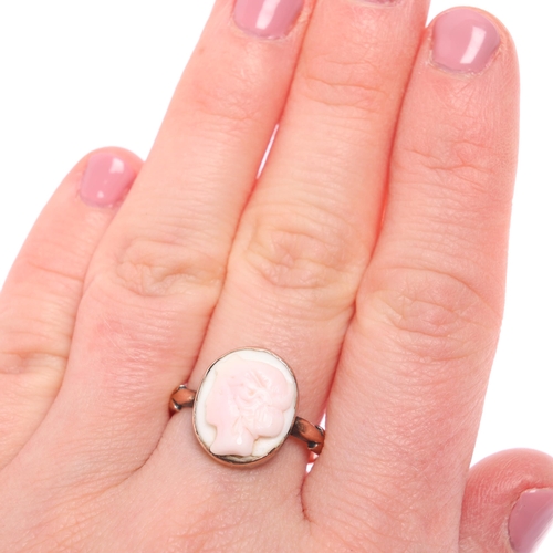 1216 - A 9ct rose gold pink conch shell cameo ring, relief carved depicting female profile, setting height ... 