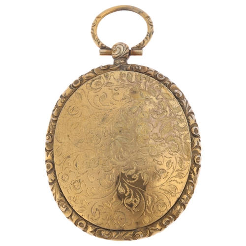 1219 - A large Antique Victorian gold plated locket pendant, oval form with allover engraved floral decorat... 