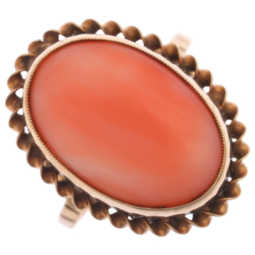 1238 - A 9ct gold coral dress ring, rub over set with oval cabochon coral within rope twist surround, setti... 