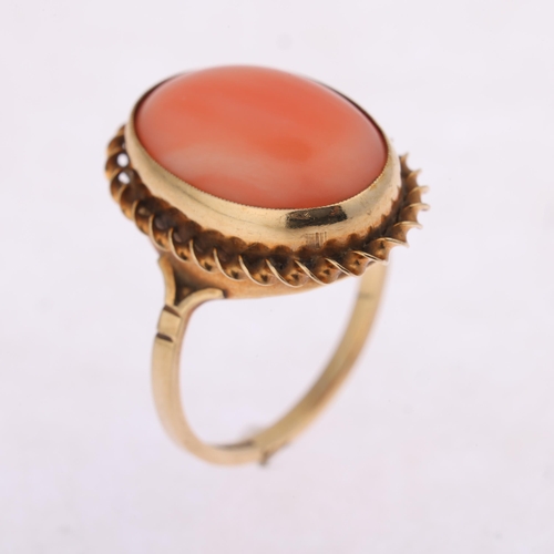 1238 - A 9ct gold coral dress ring, rub over set with oval cabochon coral within rope twist surround, setti... 