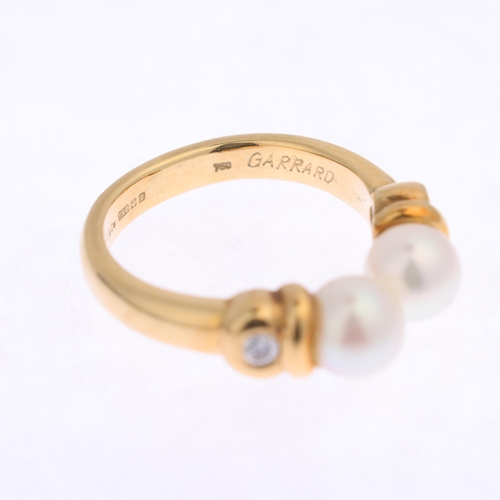 1245 - GARRARD - an 18ct gold pearl and diamond torque ring, maker G&Co, import London 1993, set with 5.9mm... 