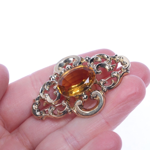 1289 - An Antique Victorian 9ct gold citrine brooch, rub over set with oval mixed-cut citrine within openwo... 