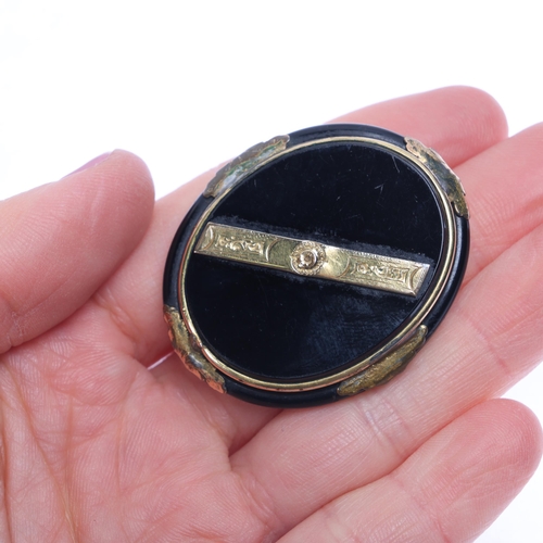 1294 - An Antique Victorian onyx mourning brooch, with applied gilt-metal mounts, 43.3mm, 12.6g