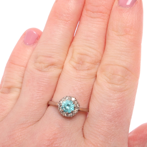 1304 - An 18ct white gold blue zircon and diamond cluster ring, maker MBG, London 1960, setting height 9.1m... 