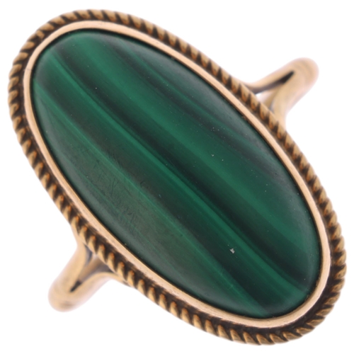 1312 - A 9ct gold malachite dress ring, rub over set with oval cabochon malachite within rope twist surroun... 