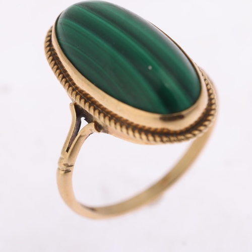 1312 - A 9ct gold malachite dress ring, rub over set with oval cabochon malachite within rope twist surroun... 