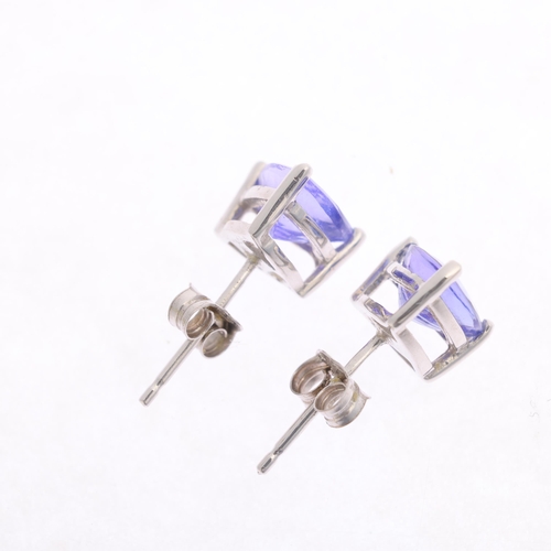 1322 - A pair of 18ct white gold single stone tanzanite stud earrings, claw set with trillion-cut tanzanite... 