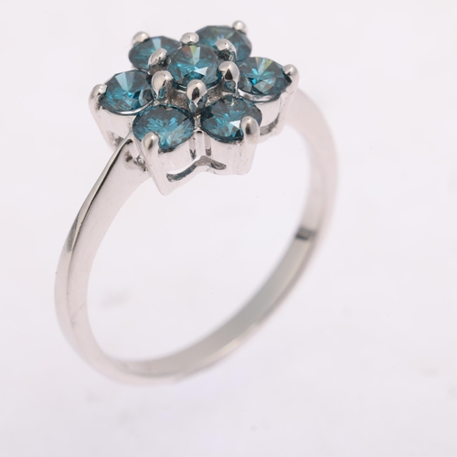 1323 - An 18ct white gold blue diamond flowerhead cluster ring, maker DK, Birmingham 2007, claw set with mo... 