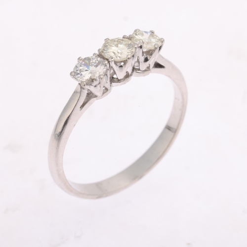 1359 - A platinum three stone diamond ring, claw set with modern round brilliant-cut diamonds, total diamon... 