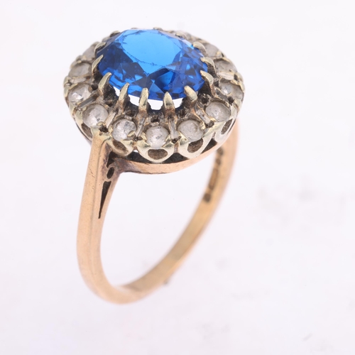 1385 - A 9ct gold paste cluster ring, London 1973, claw set with oval mixed-cut blue paste surrounded by ro... 