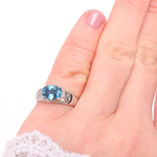 1387 - A 9ct white gold blue topaz and diamond dress ring, claw-set with oval mixed cut topax and diamond s... 