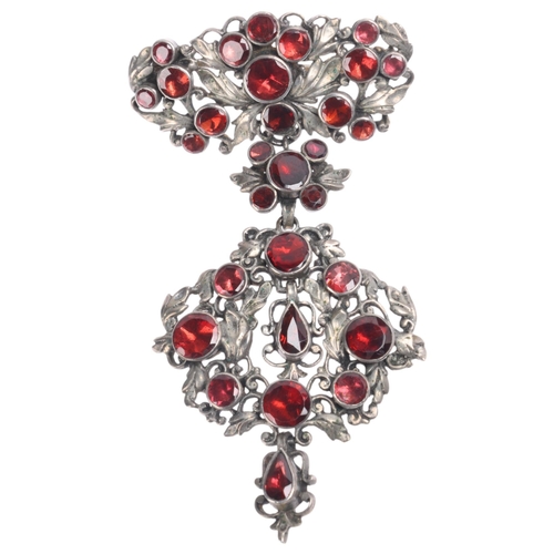 1415 - An Antique Continental silver garnet openwork drop brooch, maker GA, rub over set with round and pea... 