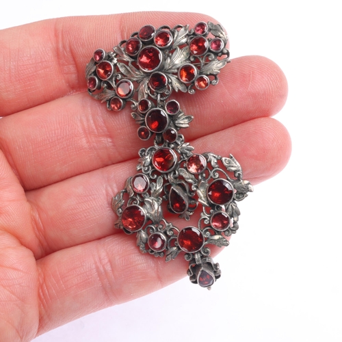 1415 - An Antique Continental silver garnet openwork drop brooch, maker GA, rub over set with round and pea... 