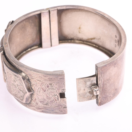 1420 - An Antique silver belt buckle hinged bangle, by Kirwan & Co Ltd, Birmingham 1934, band width 25.1mm,... 